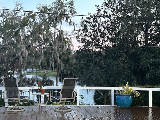 wooden terrace featuring a water view