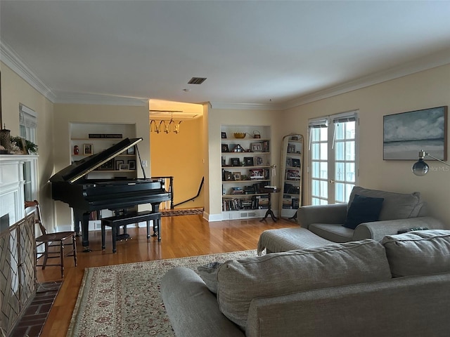 living area featuring ornamental molding and wood finished floors