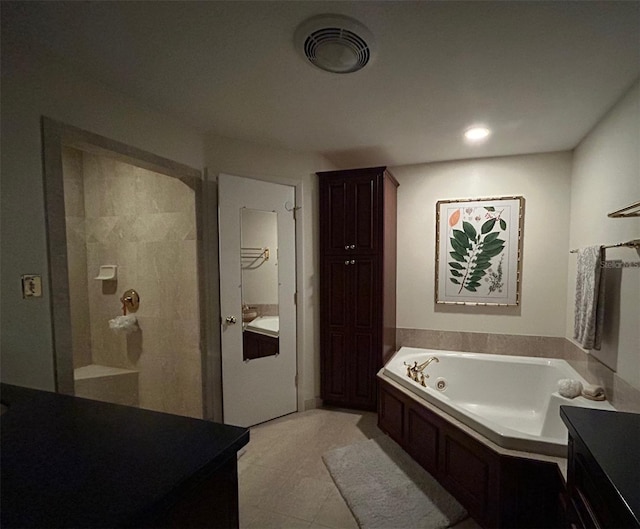 bathroom with a stall shower, visible vents, a garden tub, and vanity