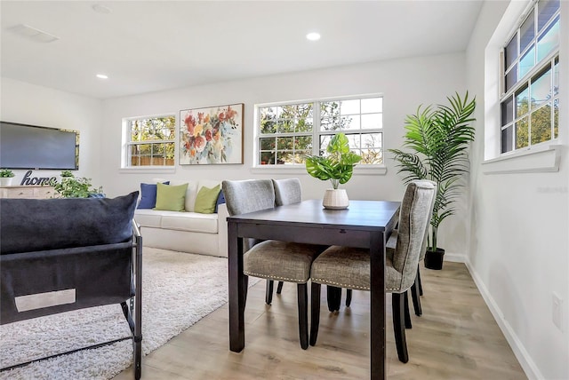 dining room featuring light wood-type flooring, baseboards, and recessed lighting