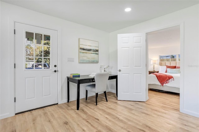 office with light wood-type flooring and recessed lighting