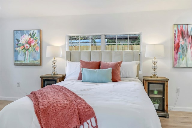 bedroom featuring baseboards and light wood-style floors