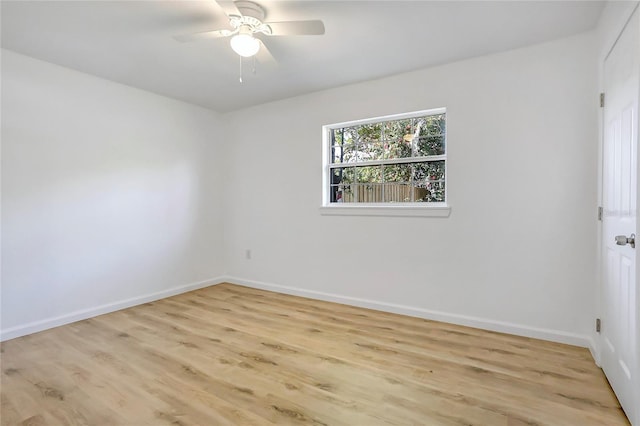 empty room featuring light wood-style flooring, baseboards, and ceiling fan