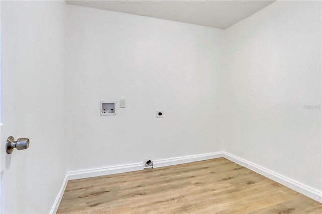 clothes washing area with laundry area, baseboards, wood finished floors, washer hookup, and electric dryer hookup