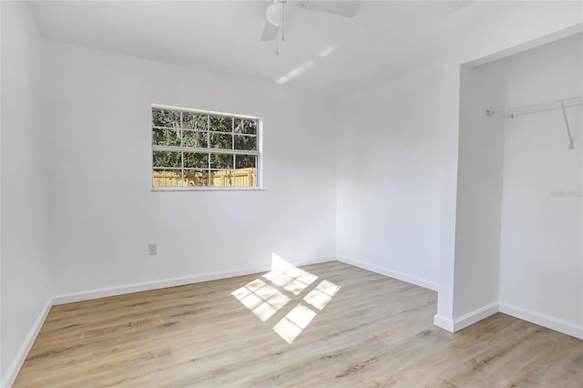 unfurnished bedroom featuring light wood finished floors, baseboards, and a ceiling fan