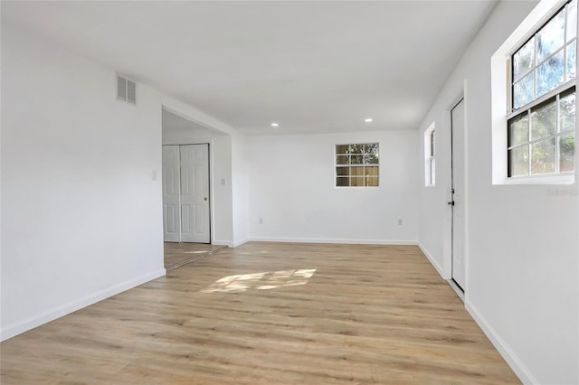 unfurnished room featuring light wood-style flooring, visible vents, baseboards, and recessed lighting