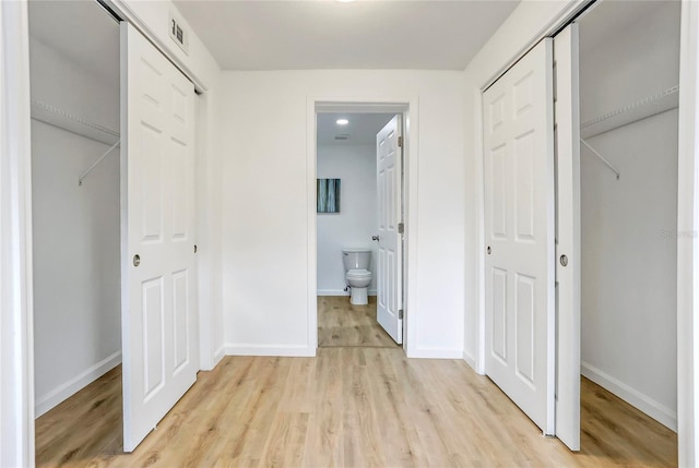 unfurnished bedroom with light wood-type flooring, baseboards, and visible vents