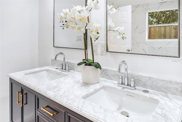 full bath featuring double vanity and a sink