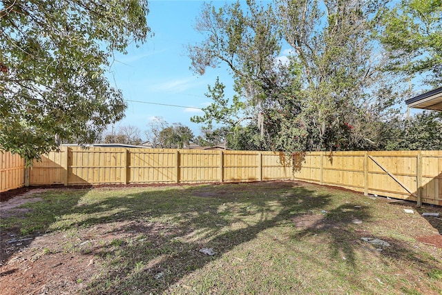 view of yard with a fenced backyard