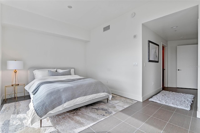 tiled bedroom with visible vents and baseboards