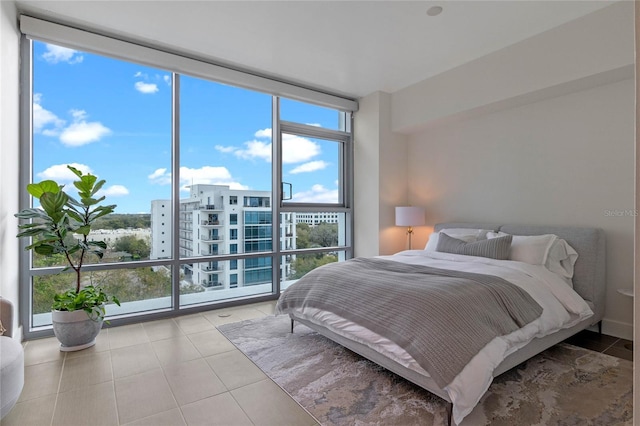 tiled bedroom with floor to ceiling windows and multiple windows