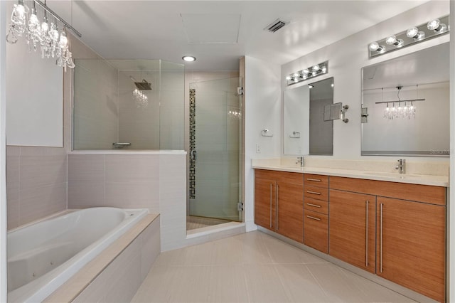 full bathroom with double vanity, a stall shower, visible vents, a garden tub, and a sink