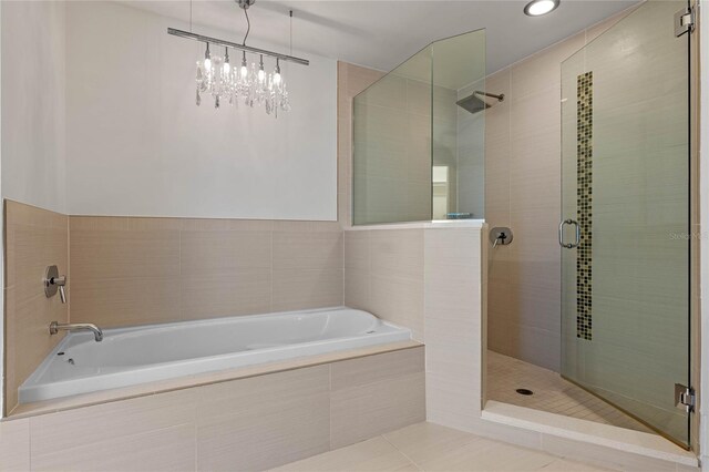 full bath featuring a garden tub, tile patterned flooring, and a shower stall