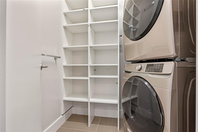 laundry area featuring stacked washer and dryer and laundry area