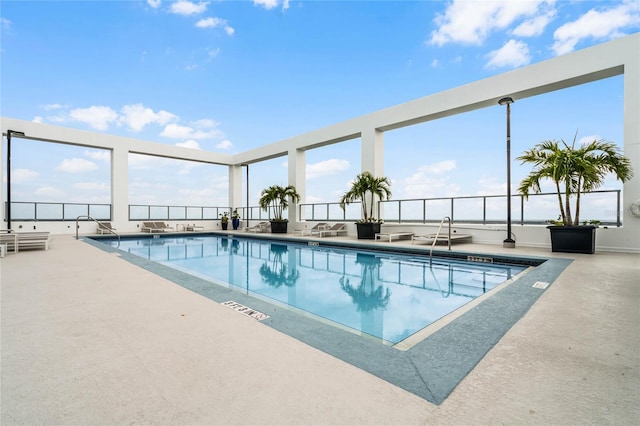 community pool with a patio area