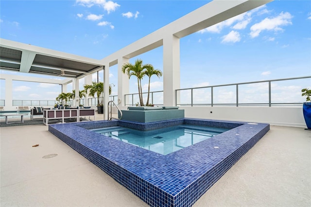 view of pool with a hot tub, outdoor lounge area, and a patio