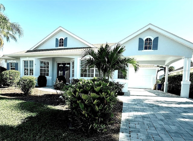 view of front of house featuring decorative driveway and stucco siding