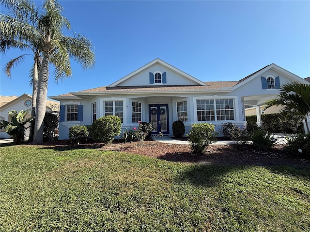 view of front of property featuring french doors, a front lawn, and stucco siding