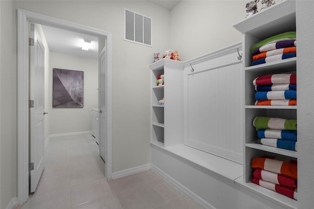 mudroom with visible vents, baseboards, and light tile patterned floors