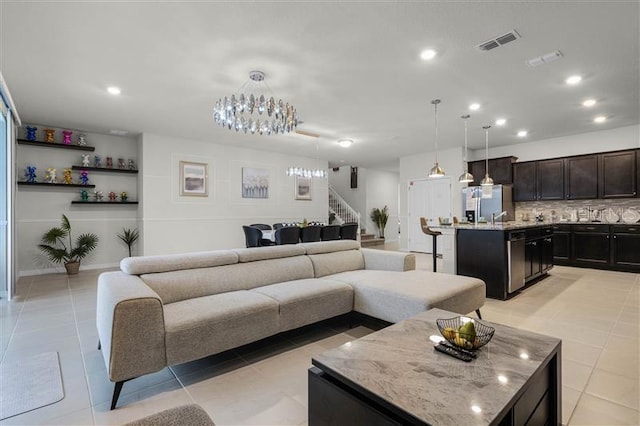 living room with stairs, light tile patterned floors, visible vents, and recessed lighting