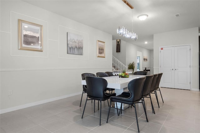 dining room with light tile patterned floors, visible vents, baseboards, stairway, and an inviting chandelier