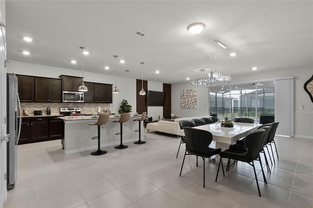 dining room featuring light tile patterned flooring, baseboards, visible vents, and recessed lighting