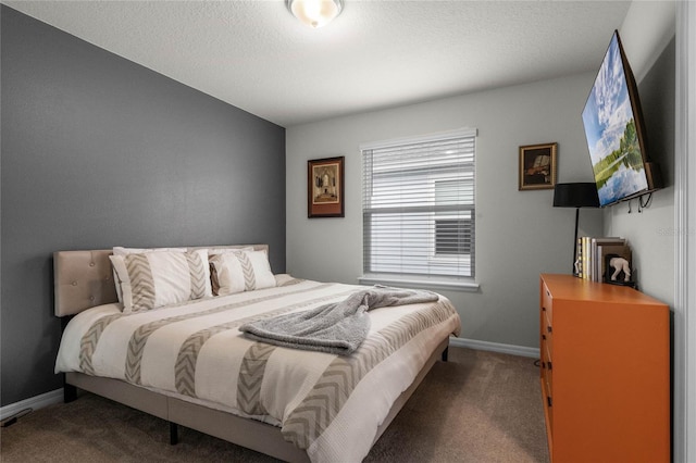 carpeted bedroom featuring a textured ceiling and baseboards