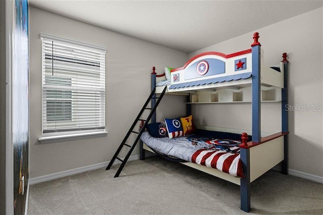 carpeted bedroom featuring baseboards