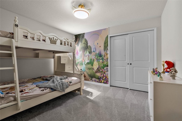 bedroom featuring a closet, light carpet, and a textured ceiling