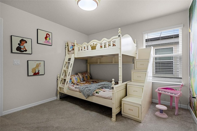 bedroom featuring light colored carpet and baseboards