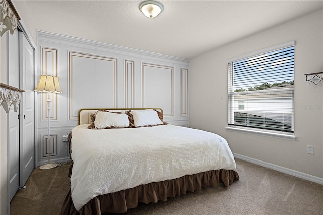 carpeted bedroom with baseboards