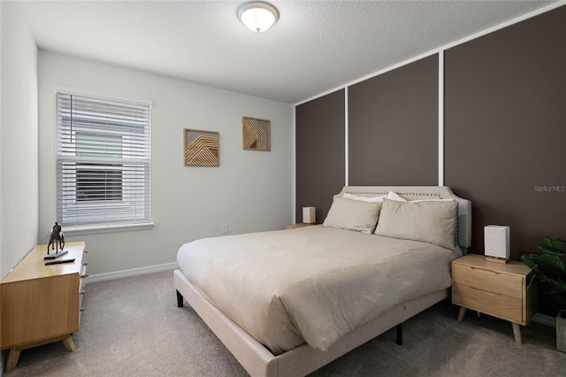 carpeted bedroom with a textured ceiling and baseboards