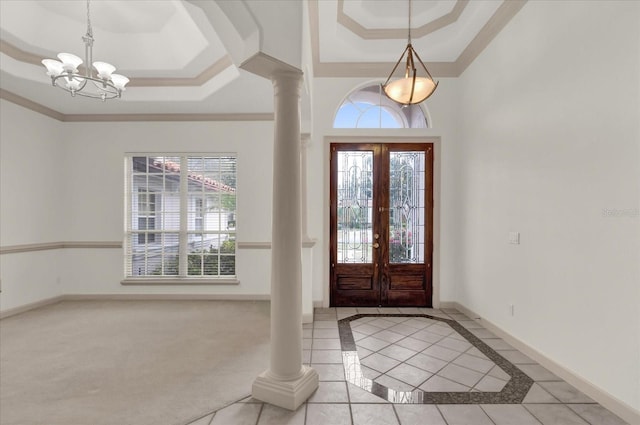 10616 Emerald Chase Dr, Orlando, FL 32836 - entryway with decorative columns, baseboards, a tray ceiling, crown molding, and a notable chandelier