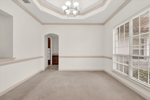 10616 Emerald Chase Dr, Orlando, FL 32836 - empty room with arched walkways, a raised ceiling, light colored carpet, and baseboards