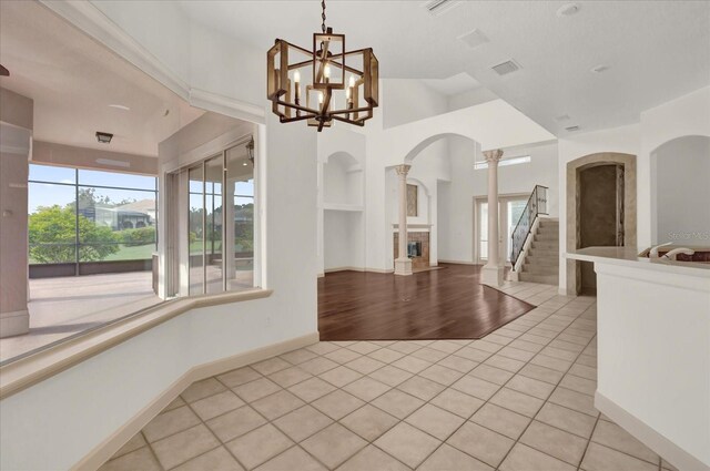 10616 Emerald Chase Dr, Orlando, FL 32836 - unfurnished room with light tile patterned floors, a fireplace, visible vents, and a wealth of natural light