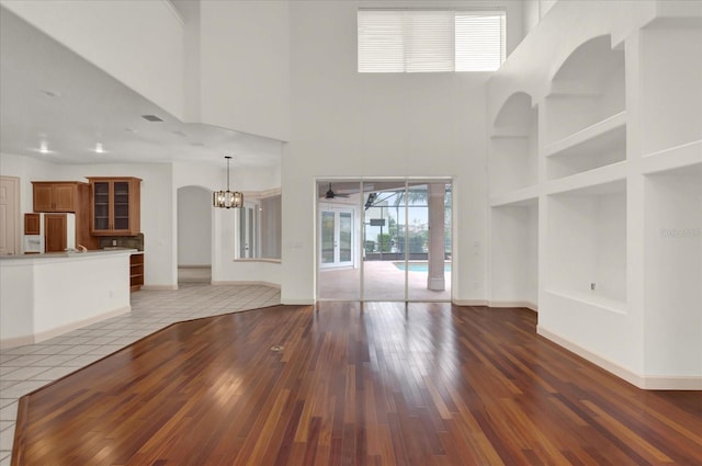 10616 Emerald Chase Dr, Orlando, FL 32836 - unfurnished living room featuring baseboards, dark wood finished floors, and built in features