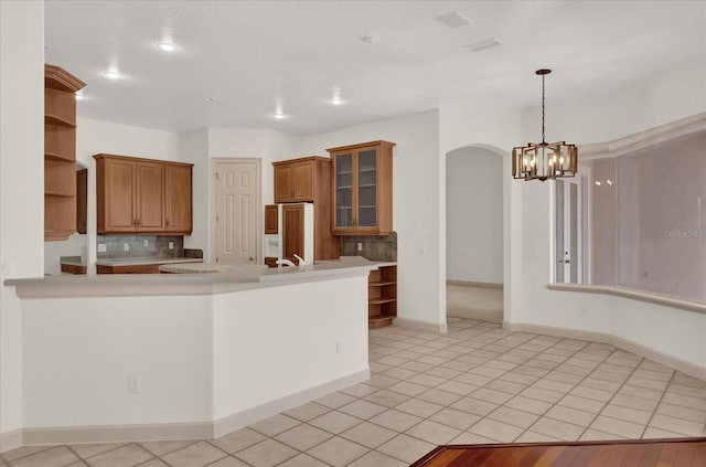 10616 Emerald Chase Dr, Orlando, FL 32836 - kitchen with decorative light fixtures, open shelves, light countertops, glass insert cabinets, and paneled refrigerator