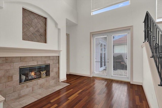 10616 Emerald Chase Dr, Orlando, FL 32836 - unfurnished living room featuring baseboards, a fireplace, stairway, and dark wood-style flooring