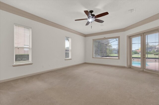 10616 Emerald Chase Dr, Orlando, FL 32836 - empty room featuring ceiling fan, light colored carpet, visible vents, baseboards, and crown molding