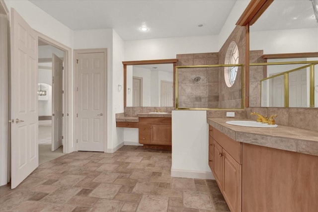 10616 Emerald Chase Dr, Orlando, FL 32836 - bathroom with a shower stall, stone finish floor, two vanities, and a sink