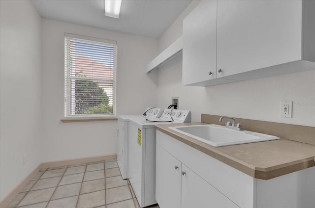 10616 Emerald Chase Dr, Orlando, FL 32836 - laundry room featuring light tile patterned flooring, a sink, baseboards, cabinet space, and washer and clothes dryer