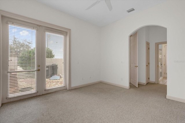 10616 Emerald Chase Dr, Orlando, FL 32836 - empty room with arched walkways, light carpet, visible vents, and baseboards