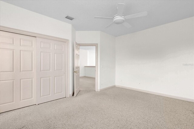 10616 Emerald Chase Dr, Orlando, FL 32836 - unfurnished bedroom featuring baseboards, visible vents, a ceiling fan, light colored carpet, and a closet