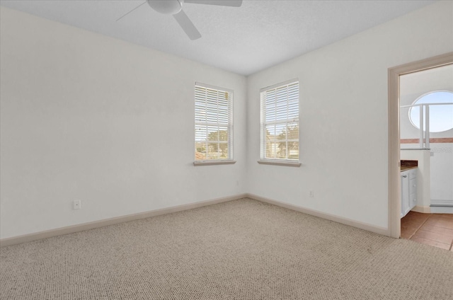 10616 Emerald Chase Dr, Orlando, FL 32836 - empty room with a ceiling fan, light carpet, and baseboards
