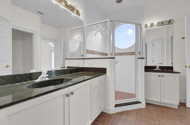 10616 Emerald Chase Dr, Orlando, FL 32836 - full bathroom featuring a stall shower, tile patterned flooring, two vanities, and a sink