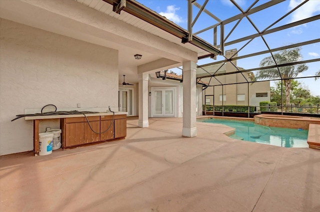 10616 Emerald Chase Dr, Orlando, FL 32836 - pool featuring glass enclosure, an in ground hot tub, french doors, and a patio