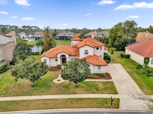 10616 Emerald Chase Dr, Orlando, FL 32836 - mediterranean / spanish-style home featuring a tiled roof, driveway, a residential view, stucco siding, and a front yard