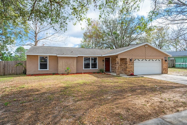 single story home with a garage, fence, concrete driveway, stucco siding, and a front lawn