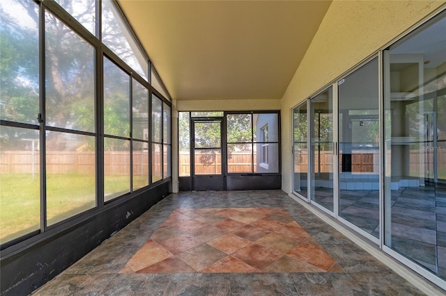 unfurnished sunroom with lofted ceiling