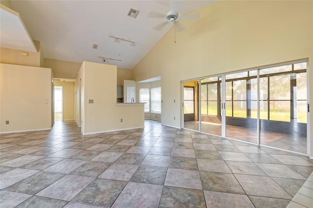 unfurnished living room with high vaulted ceiling, baseboards, visible vents, and rail lighting